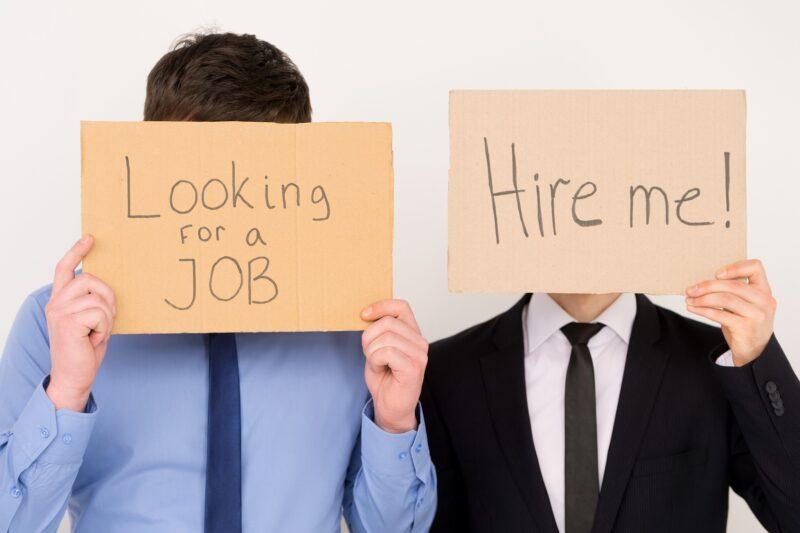 Unemployed Office Workers Holding Cardboard Signs Job Hunting
