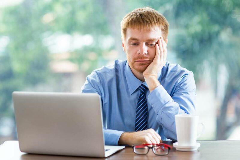 Tired Young Businessman With Laptop